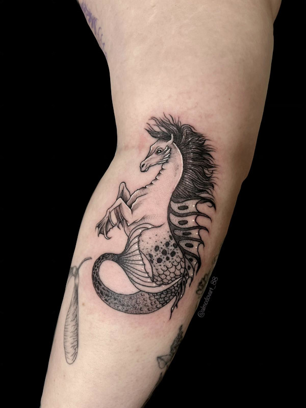 Black and grey fine line forearm tattoo of a horse mermaid tattooed by Sacred Mandala Studio artist Lita Almodovar.
